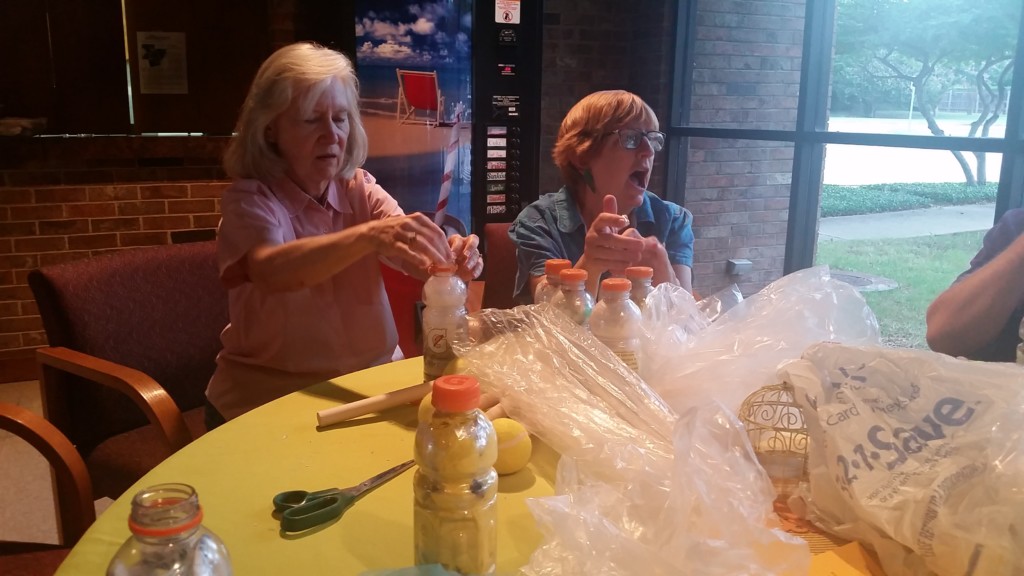 Citizens of the DFW Metroplex gather to create plastic bottle bricks.