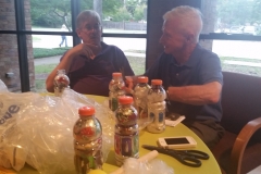 Dr. Charles Barker and Ron Bemis of Compassionate DFW stuff Gatorade bottles with discarded plastic scraps to create bricks.