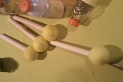 Wooden dowels come in pretty handy when trying to press and compact the plastic within the Gatorade bottles! The tennis balls help you maintain a strong grip. You'll be amazed at how much you can fit into each bottle!